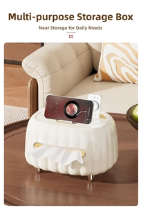 Detail of cream wavy tissue box with rose gold feet and integrated remote storage