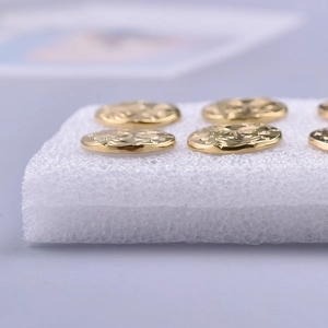 Macro shot of 304 stainless steel gold heart earrings with irregular relief patterns