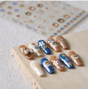 Detailed macro view of 3D embossed nail art stickers featuring bears and bows