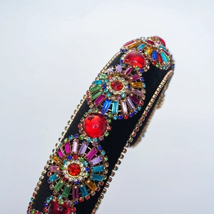 Macro shot of colorful rhinestones and red gemstones on a baroque sponge headband