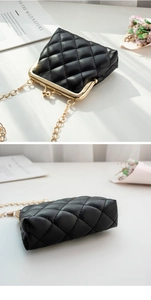 Detail of black quilted mini bag with gold chain strap and metal clasp closure