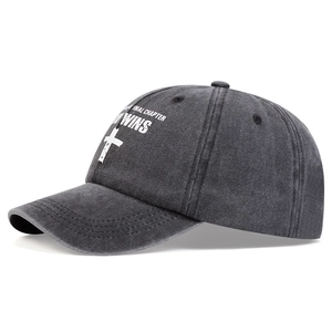 Washed dark grey baseball cap with cross print and God Wins lettering in a side view