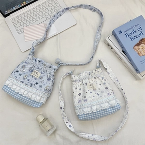 Close-up of cute cartoon bucket bags with lace edges and heart embroidery details