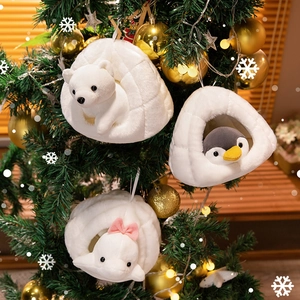 Three plush igloo Christmas ornaments featuring polar bear, penguin and whale on a festive tree