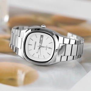 Macro shot of silver stainless steel square watch with dual calendar and white dial details