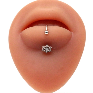 Detail of silver flower lip stud with clear gemstone on silicone mouth model