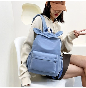 Detail shot of blue school backpack with cute rabbit ears showing spacious side profile