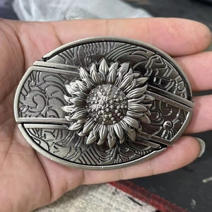 Detailed relief of a sunflower on a vintage antique silver metal belt buckle