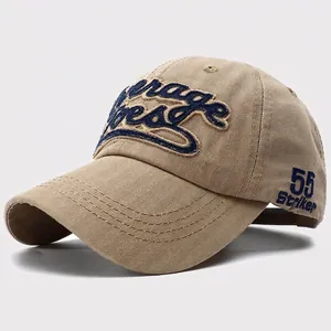 Detail of dark khaki twill cotton baseball cap with blue embroidery and 55 Striker logo