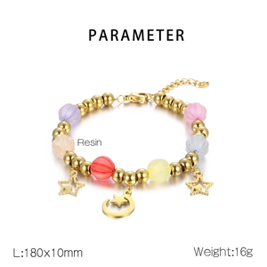 Detail of colorful resin pumpkin beads and golden steel star charms on a beaded bracelet