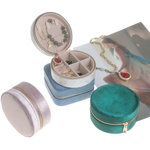 Detail view of round and square velvet jewelry cases with zipper and interior sections