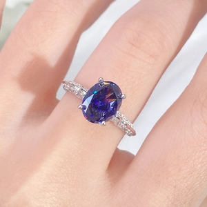 S925 sterling silver angel wing ring with oval tanzanite purple gemstone on female finger