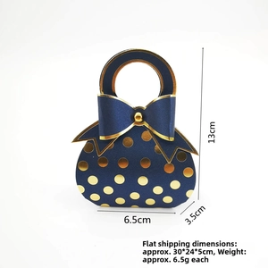 Detail of dark blue gift box with gold dots, bow accent and 13cm height dimensions