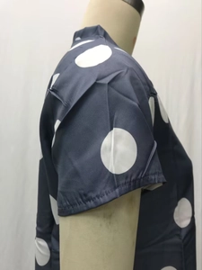 Detail of dark blue short sleeve with white polka dot pattern and fine stitching quality