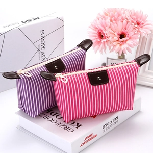 Striped waterproof makeup bags in purple and pink with leather pulls and metal zippers