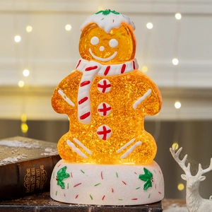 Lighted gingerbread man snow globe with glitter and festive scarf for Christmas gifts