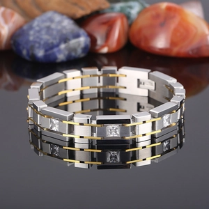 Detailed close-up of men's stainless steel bracelet with cubic zirconia on black mirror
