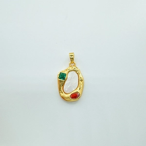 Detail of irregular gold pendant with white shell inlay and colorful cubic zirconia
