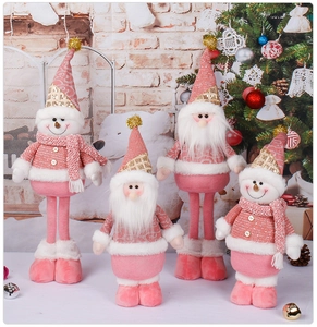 Detail of plush pink and white Christmas dolls with sequins and knit textures