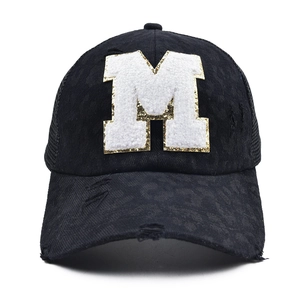 Detailed macro of black leopard baseball cap with sequined towel embroidery M letter