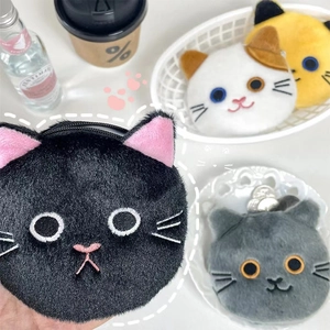 Close-up of colorful plush cat coin purses showing soft fur texture and zip closure