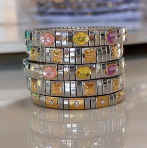 Stacked stretch stainless steel bracelets with butterfly charms and colorful gemstones