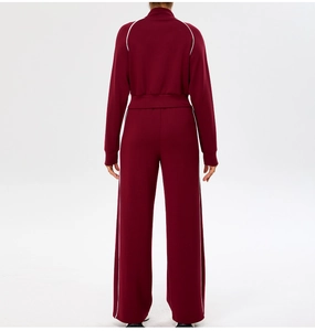 Rear view of burgundy yoga tracksuit featuring white side stripes on jacket and trousers