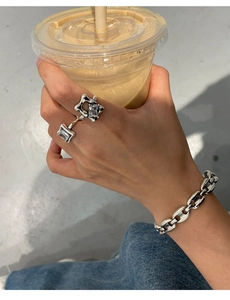 Detailed view of silver 925 rings and chain bracelet with star charms and crystals