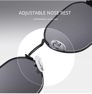 Detail view of adjustable silicone nose pads on black metal sunglasses frame