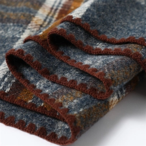 Detail shot of blue and brown plaid scarf with high-quality stitching and soft texture