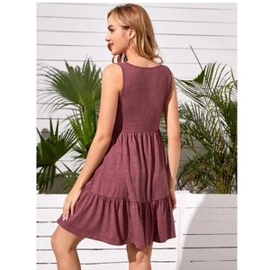 Outdoor shot of sleeveless mauve tiered A-line maternity dress with layered ruffle skirt