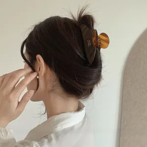 Detail of tortoise shell acetate shark hair clip with a minimalist barrette design