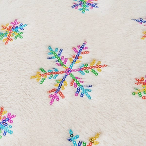 White faux fur pillow cover with colorful sequin snowflake embroidery for Christmas decor