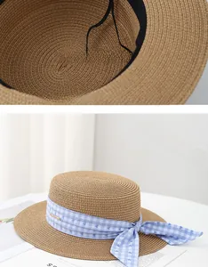 Detail of internal adjustable strap on a flat top straw hat with heart ribbon