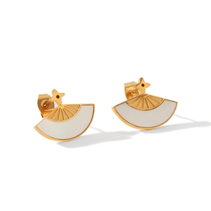 Detailed close-up of golden fan-shaped earrings with white shell inlay and star stud
