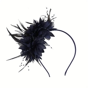 Detailed close-up of dark blue bridal fascinator with mesh, feathers and beadwork