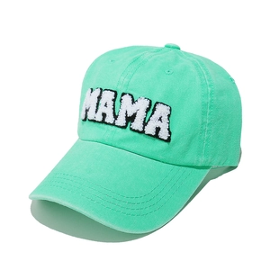 Close-up of MAMA towel embroidery on mint green washed cotton baseball cap