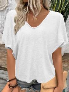 Detail of loose fit white V-neck T-shirt showing soft fabric texture and batwing sleeves