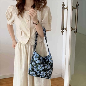 Vintage floral jacquard shoulder bag with blue flowers on black canvas material