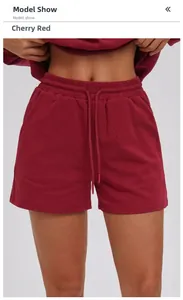 Close-up of cherry red sports shorts featuring a drawstring waist and knit texture