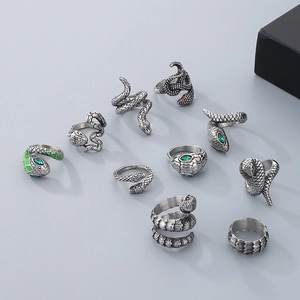 Vintage silver snake rings set with ruby and emerald gemstone eyes in punk style
