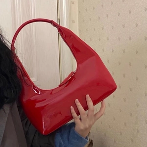 Retro red patent leather crescent handbag with glossy finish and shoulder strap