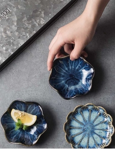 Detailed top view of reactive glaze ceramic snack plates with vintage petal design textures