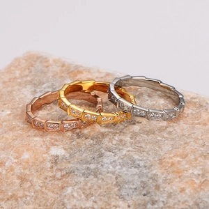 Three-color geometric snake scale rings set in gold, rose gold, and silver with pavé crystals