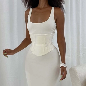 Detail of the white sleeveless bodice featuring a lace-up corset waist and zipper closure