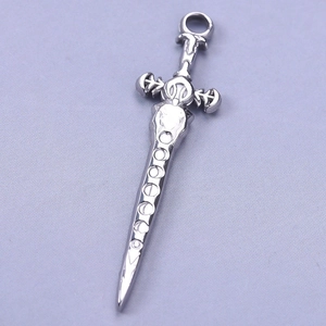 Detailed macro shot of silver 304 stainless steel sword pendant with engraved patterns