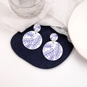 Detailed view of blue and white floral porcelain style double disc dangle earrings