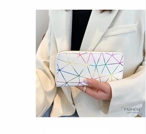 Close-up of white leather purse with rainbow geometric texture held by a hand
