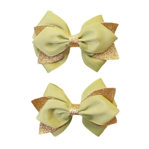 Pair of green grosgrain ribbon hair clips with gold glitter bows for girls
