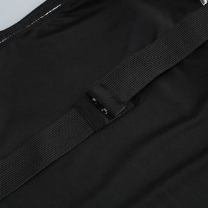 Detail of adjustable metal multi-row hooks and elastic textured strap on black strapless dress